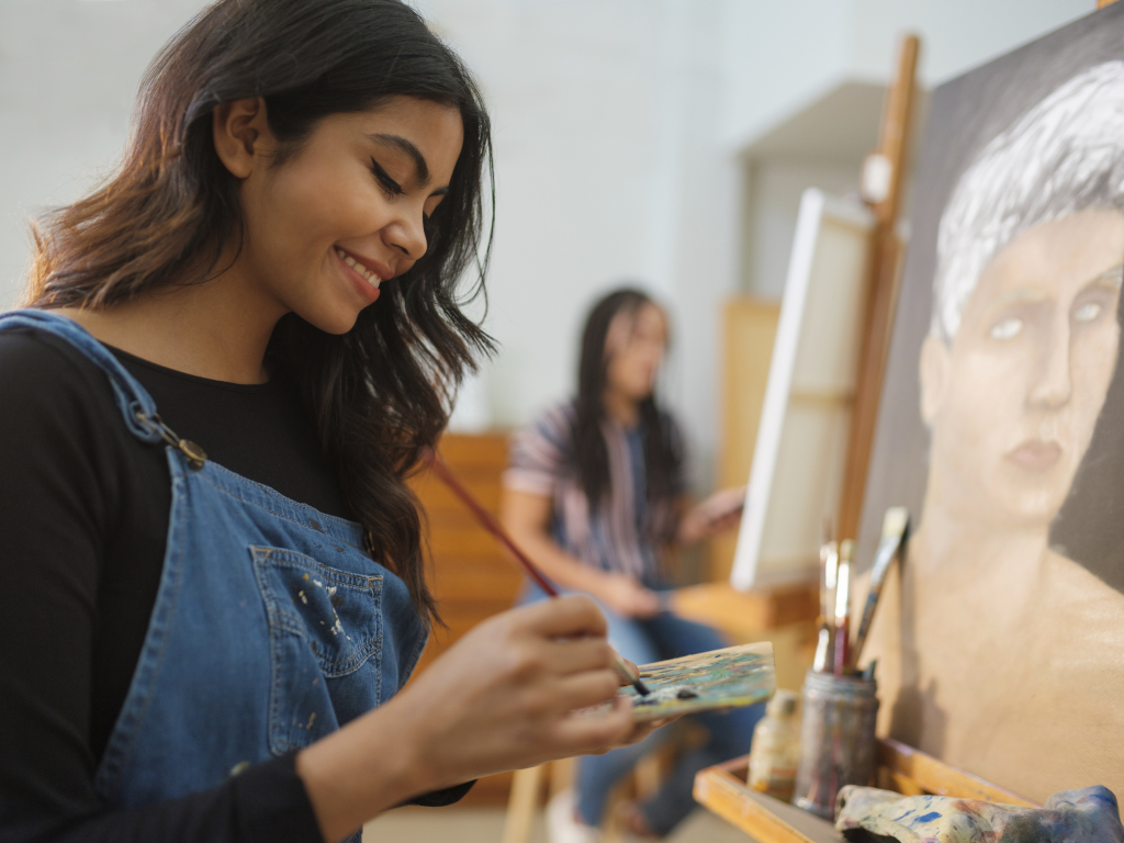 Young woman panting a portrait.