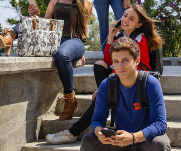 High School students sitting on school steps.